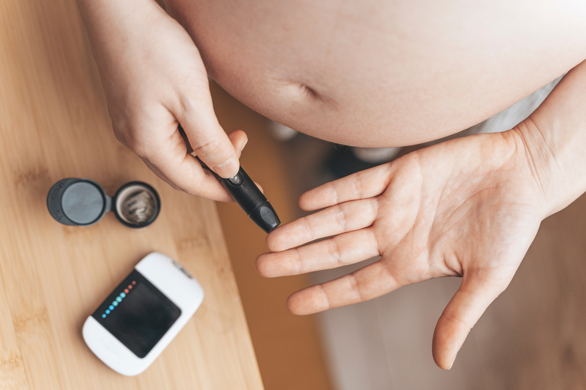 Gestational diabetes in pregnancy. Pregnant woman check sugar level with a glucometer. Glucose intolerance, diabetic fetopathy, hypoglycemia, insulin resistance concept